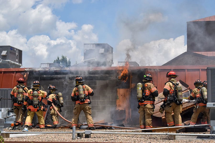 firefighters on roof of church