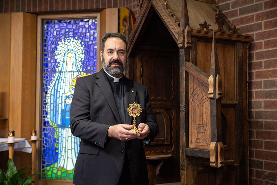 Fr. Moreno with relic outside confessional